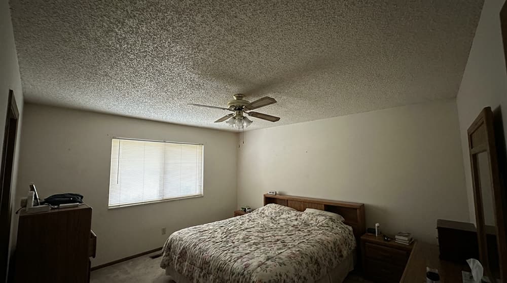 Bedroom ceiling before popcorn removal